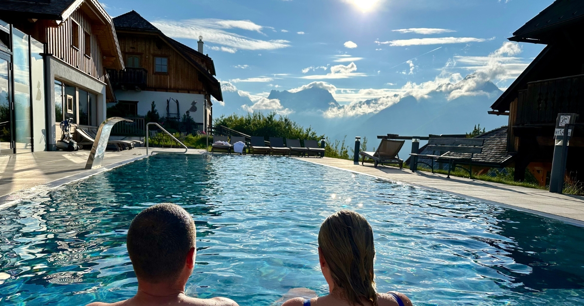 Paar im Pool mit Blick aufs Bergpanorama